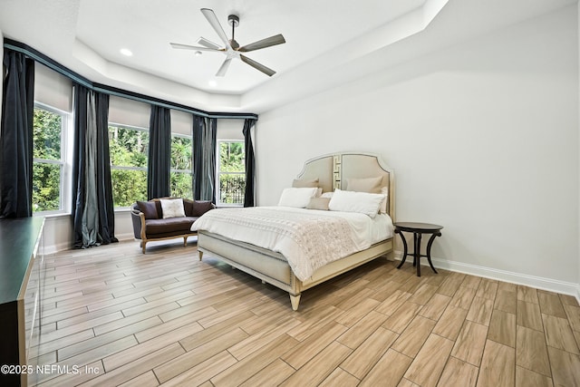2919 Brettungar Dr, Jacksonville, FL 32224 - bedroom featuring a tray ceiling, light wood-style flooring, multiple windows, recessed lighting, and ceiling fan