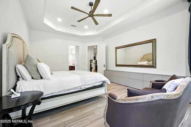 2919 Brettungar Dr, Jacksonville, FL 32224 - bedroom featuring wood finished floors, a tray ceiling, ensuite bathroom, recessed lighting, and ceiling fan