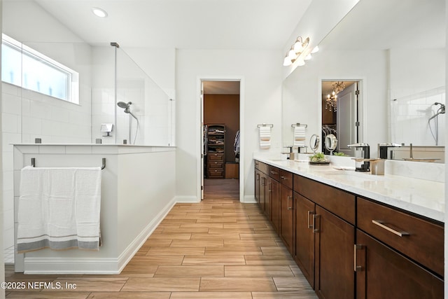 2919 Brettungar Dr, Jacksonville, FL 32224 - full bath with double vanity, a walk in closet, walk in shower, wood finished floors, and recessed lighting