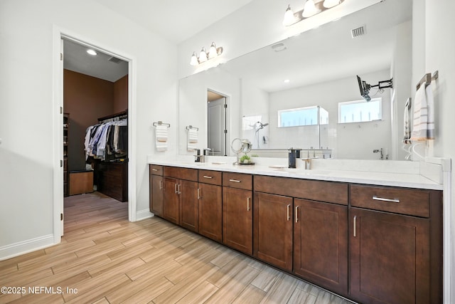 2919 Brettungar Dr, Jacksonville, FL 32224 - full bath with double vanity, wood finished floors, and a walk in closet