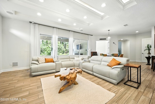 2919 Brettungar Dr, Jacksonville, FL 32224 - living room featuring arched walkways, light wood-style floors, recessed lighting, and a textured ceiling