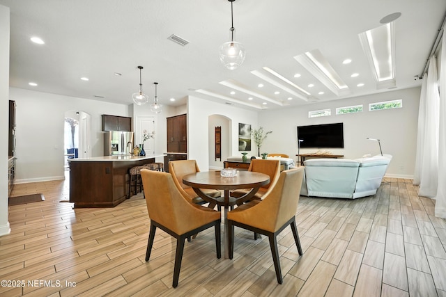 2919 Brettungar Dr, Jacksonville, FL 32224 - dining area featuring arched walkways, light wood-style floors, healthy amount of natural light, and recessed lighting