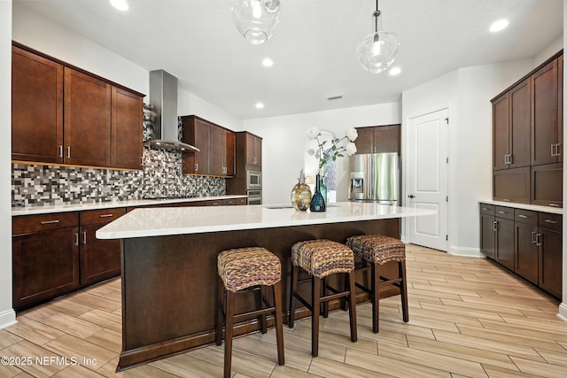 2919 Brettungar Dr, Jacksonville, FL 32224 - kitchen with wall chimney range hood, appliances with stainless steel finishes, wood finish floors, light countertops, and recessed lighting