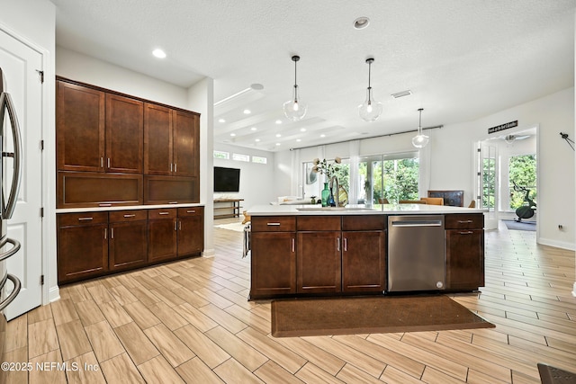 2919 Brettungar Dr, Jacksonville, FL 32224 - kitchen featuring stainless steel dishwasher, open floor plan, recessed lighting, dark brown cabinets, and pendant lighting