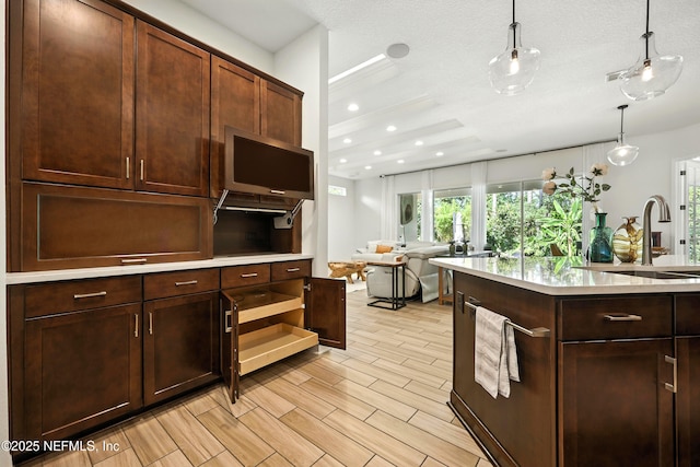 2919 Brettungar Dr, Jacksonville, FL 32224 - kitchen featuring light countertops, hanging light fixtures, open shelves, open floor plan, and dark brown cabinets