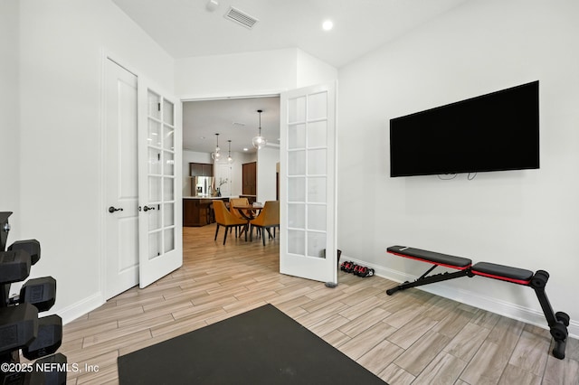 2919 Brettungar Dr, Jacksonville, FL 32224 - workout area with french doors, light wood-style flooring, and recessed lighting