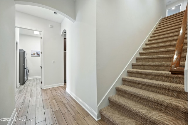 2919 Brettungar Dr, Jacksonville, FL 32224 - stairs with arched walkways and wood finish floors