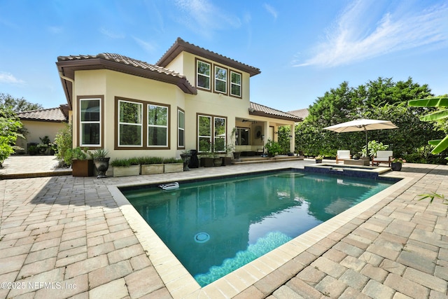 2919 Brettungar Dr, Jacksonville, FL 32224 - back of property with a patio, a tile roof, and stucco siding