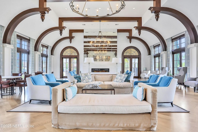 2919 Brettungar Dr, Jacksonville, FL 32224 - living area featuring a chandelier, healthy amount of natural light, a towering ceiling, and arched walkways
