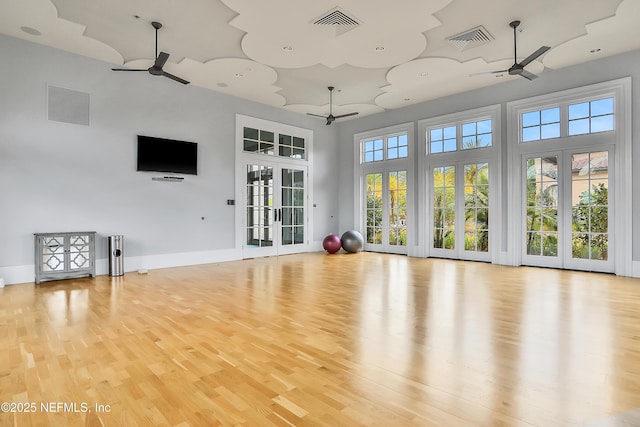 2919 Brettungar Dr, Jacksonville, FL 32224 - unfurnished living room featuring ceiling fan, light wood-type flooring, a towering ceiling, and french doors