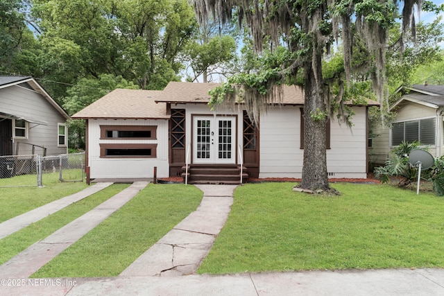654 Woodbine St, Jacksonville, FL 32206 - view of front facade with french doors and a shingled roof