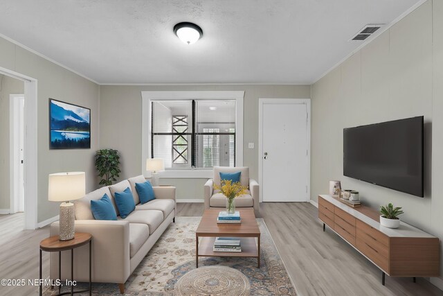 654 Woodbine St, Jacksonville, FL 32206 - living room featuring light wood-type flooring, ornamental molding, and baseboards