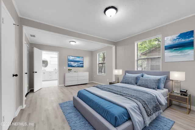 654 Woodbine St, Jacksonville, FL 32206 - bedroom featuring light wood-type flooring, crown molding, baseboards, and ensuite bath