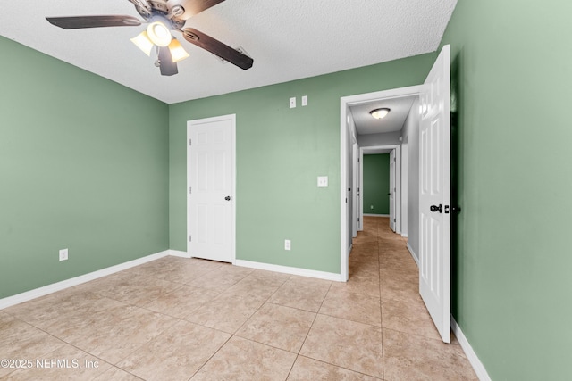 2830 Limestone Ct, Middleburg, FL 32068 - unfurnished bedroom with light tile patterned flooring, a textured ceiling, baseboards, and a ceiling fan