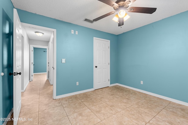 2830 Limestone Ct, Middleburg, FL 32068 - unfurnished bedroom featuring light tile patterned flooring, baseboards, a textured ceiling, and a ceiling fan