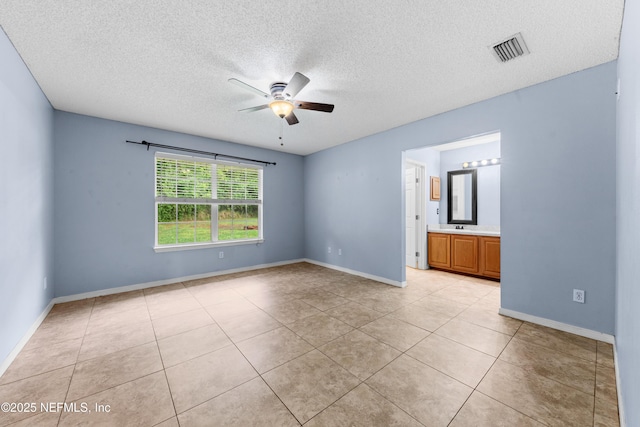 2830 Limestone Ct, Middleburg, FL 32068 - spare room featuring ceiling fan, light tile patterned flooring, a textured ceiling, and baseboards