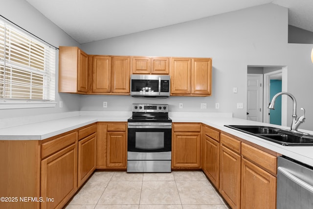 2830 Limestone Ct, Middleburg, FL 32068 - kitchen with stainless steel appliances, a sink, vaulted ceiling, and light countertops