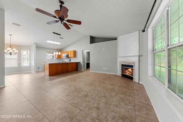 2830 Limestone Ct, Middleburg, FL 32068 - unfurnished living room featuring a chandelier, light tile patterned floors, a fireplace, a textured ceiling, and ceiling fan