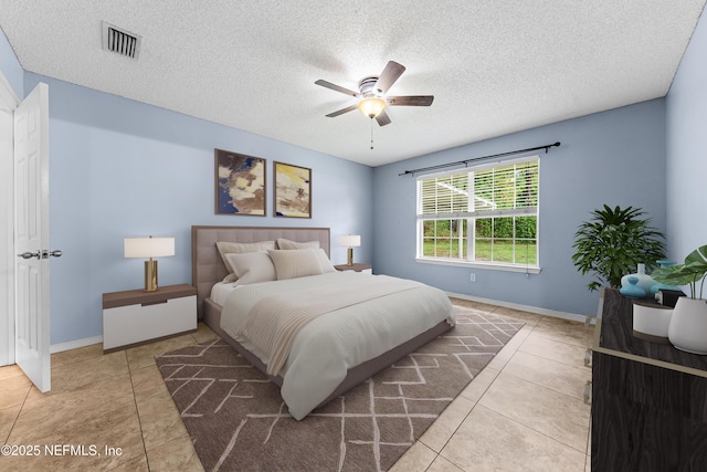 2830 Limestone Ct, Middleburg, FL 32068 - bedroom with a textured ceiling, tile patterned flooring, baseboards, and a ceiling fan