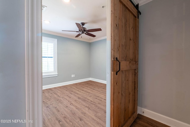 100 Fairway Park Blvd Unit 1306, Ponte Vedra Beach, FL 32082 - spare room with crown molding, wood finished floors, baseboards, a ceiling fan, and a barn door