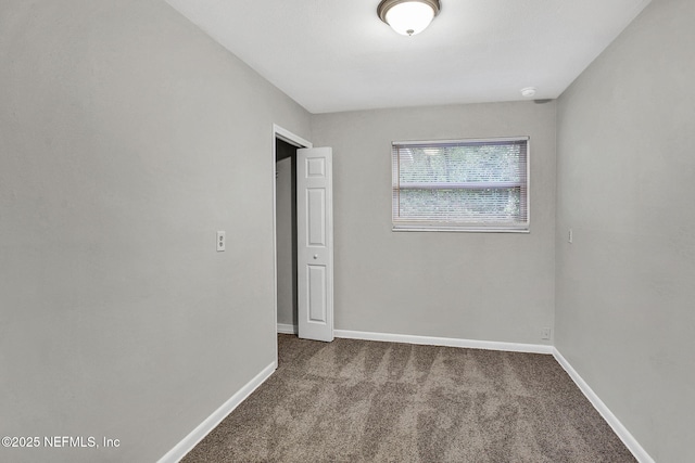 unfurnished bedroom featuring carpet floors and baseboards