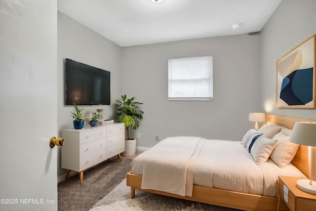 carpeted bedroom with baseboards