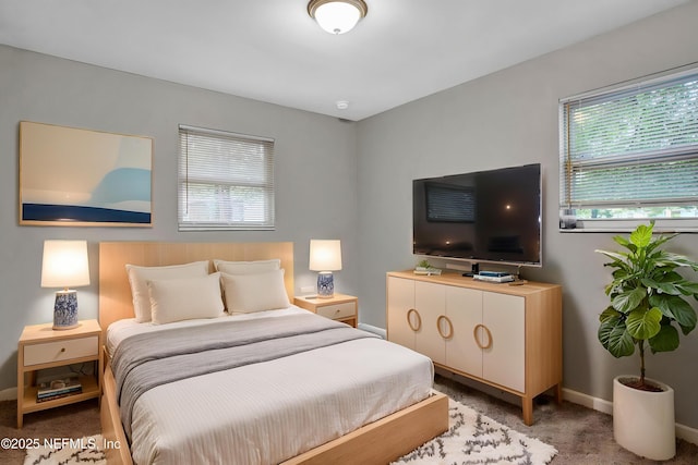 carpeted bedroom featuring baseboards
