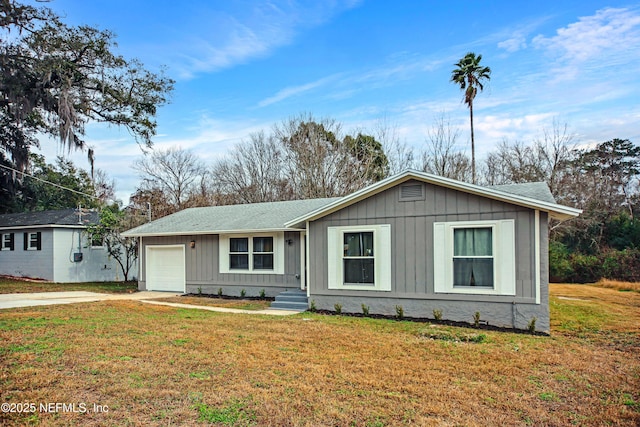 1573 Aletha Dr, Jacksonville, FL 32211 - single story home with board and batten siding, a garage, concrete driveway, and a front yard