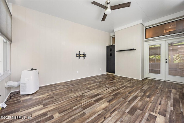 empty room featuring wood finished floors, french doors, and a ceiling fan