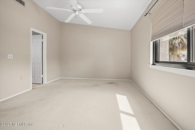 spare room with carpet floors, ceiling fan, baseboards, and lofted ceiling