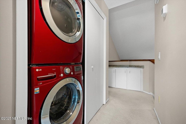 laundry area with stacked washing machine and dryer, carpet, and baseboards