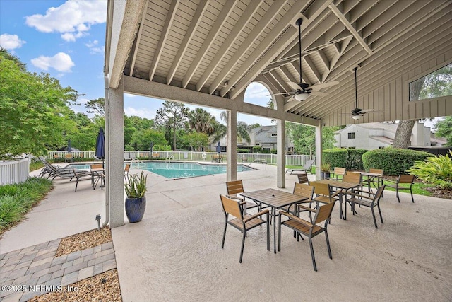 view of patio / terrace featuring fence, a ceiling fan, and a community pool