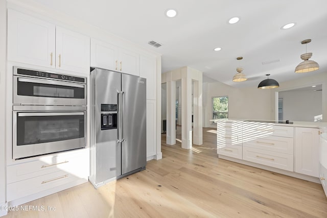 5105 Otter Creek Dr, Ponte Vedra Beach, FL 32082 - kitchen featuring appliances with stainless steel finishes, white cabinetry, light wood-style flooring, recessed lighting, and hanging light fixtures