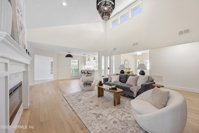 5105 Otter Creek Dr, Ponte Vedra Beach, FL 32082 - living room with light wood-style floors, baseboards, a tiled fireplace, and a high ceiling