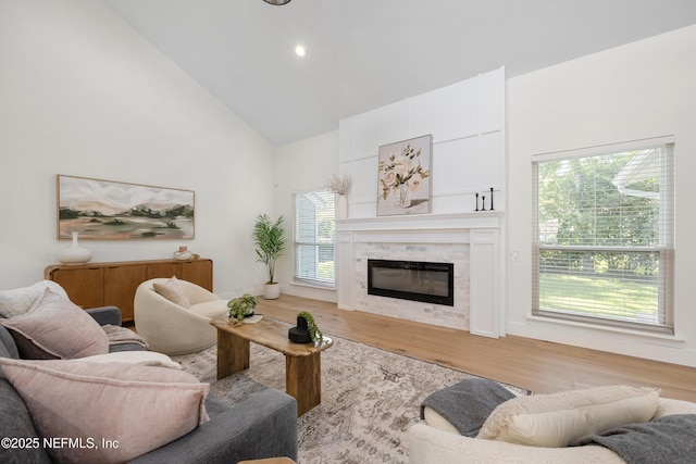 5105 Otter Creek Dr, Ponte Vedra Beach, FL 32082 - living area with high vaulted ceiling, a glass covered fireplace, wood finished floors, and recessed lighting
