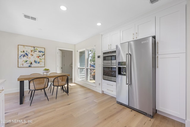 5105 Otter Creek Dr, Ponte Vedra Beach, FL 32082 - kitchen featuring appliances with stainless steel finishes, white cabinetry, light wood-style flooring, baseboards, and recessed lighting