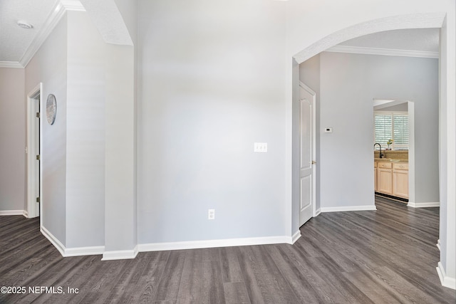 2120 Stone Creek Dr Unit E, Fleming Island, FL 32003 - empty room with ornamental molding, dark wood-style floors, arched walkways, and baseboards