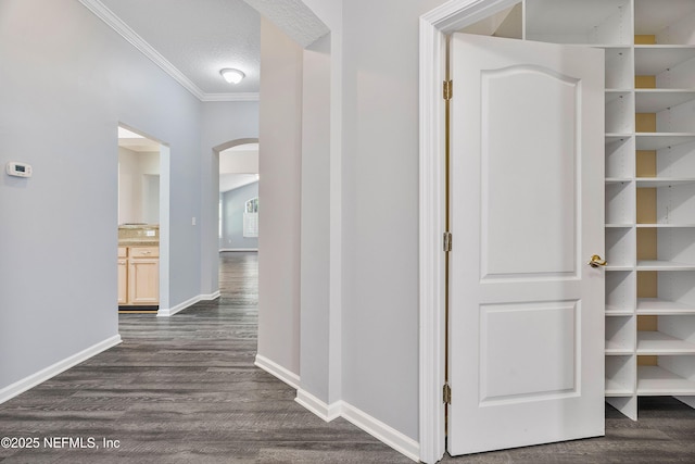 2120 Stone Creek Dr Unit E, Fleming Island, FL 32003 - hallway with arched walkways, crown molding, dark wood-style floors, and baseboards