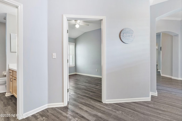 2120 Stone Creek Dr Unit E, Fleming Island, FL 32003 - hall with arched walkways, dark wood finished floors, baseboards, vaulted ceiling, and crown molding