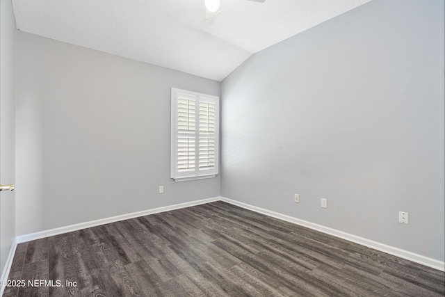 2120 Stone Creek Dr Unit E, Fleming Island, FL 32003 - unfurnished room featuring dark wood-style floors, baseboards, vaulted ceiling, and a ceiling fan