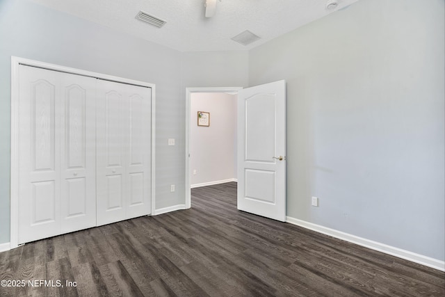 2120 Stone Creek Dr Unit E, Fleming Island, FL 32003 - unfurnished bedroom with dark wood-style floors, a closet, baseboards, and ceiling fan