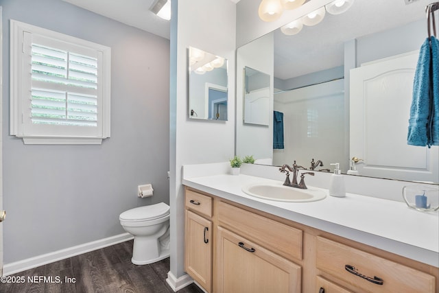 2120 Stone Creek Dr Unit E, Fleming Island, FL 32003 - full bath with toilet, vanity, wood finished floors, a shower, and baseboards