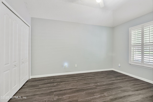 2120 Stone Creek Dr Unit E, Fleming Island, FL 32003 - unfurnished bedroom featuring a closet, dark wood-style flooring, baseboards, and a ceiling fan