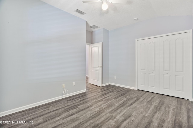 2120 Stone Creek Dr Unit E, Fleming Island, FL 32003 - unfurnished bedroom featuring wood finished floors, lofted ceiling, a closet, baseboards, and a ceiling fan