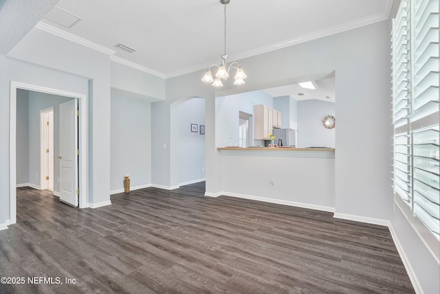 2120 Stone Creek Dr Unit E, Fleming Island, FL 32003 - unfurnished living room with arched walkways, dark wood finished floors, ornamental molding, baseboards, and a chandelier