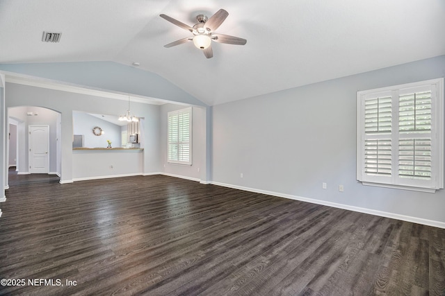 2120 Stone Creek Dr Unit E, Fleming Island, FL 32003 - unfurnished living room featuring ceiling fan, dark wood-style flooring, lofted ceiling, arched walkways, and a chandelier