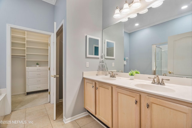2120 Stone Creek Dr Unit E, Fleming Island, FL 32003 - bathroom featuring tile patterned floors, double vanity, a shower with door, and baseboards