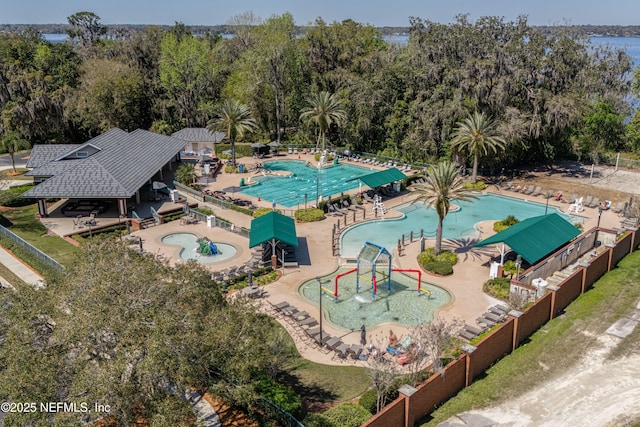 2120 Stone Creek Dr Unit E, Fleming Island, FL 32003 - drone / aerial view of a pool area and a tree filled landscape