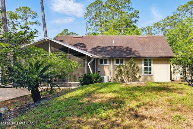 12613 Deeder Ln, Jacksonville, FL 32258 - view of front of property with stucco siding, a front lawn, central AC, and roof with shingles