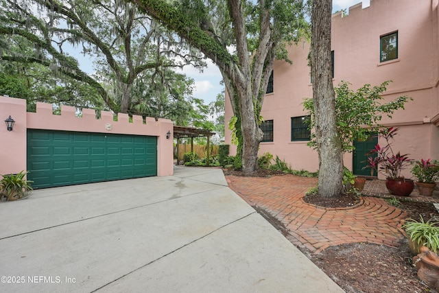 16 May St, Saint Augustine, FL 32084 - view of side of home featuring stucco siding and driveway